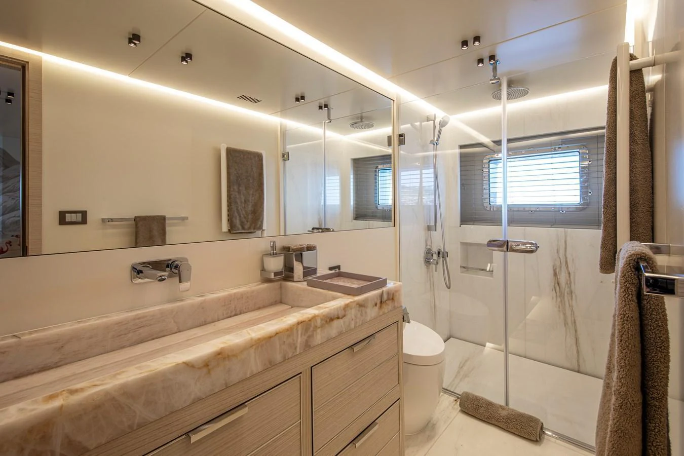 The yacht's bathroom features a luxurious design with a spacious shower and elegant fixtures. aboard OSCAR Yacht for Sale