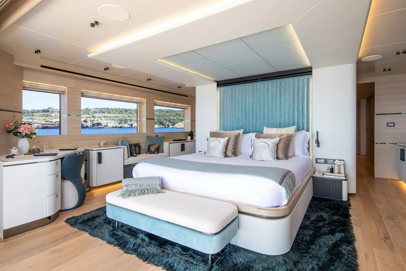 The master stateroom features a luxurious bed with elegant decor and large windows offering scenic views. aboard OSCAR Yacht for Sale