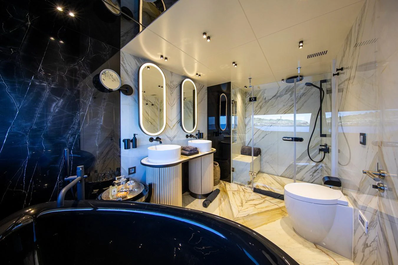 The luxurious bathroom features elegant marble finishes and modern fixtures. aboard OSCAR Yacht for Sale