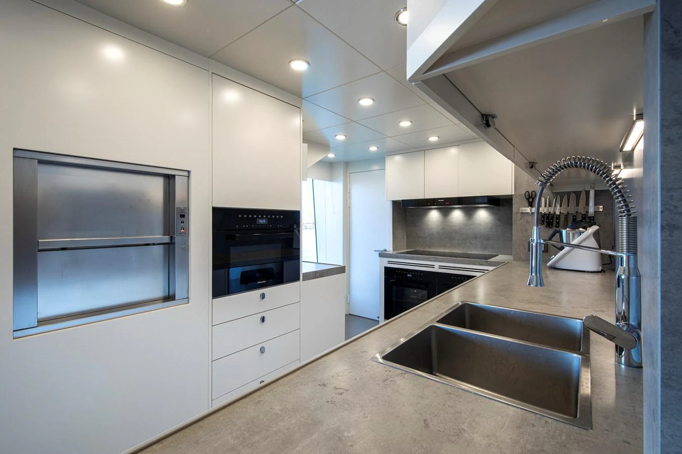 The modern galley features sleek cabinetry and high-end appliances, perfect for gourmet cooking at sea. aboard OSCAR Yacht for Sale