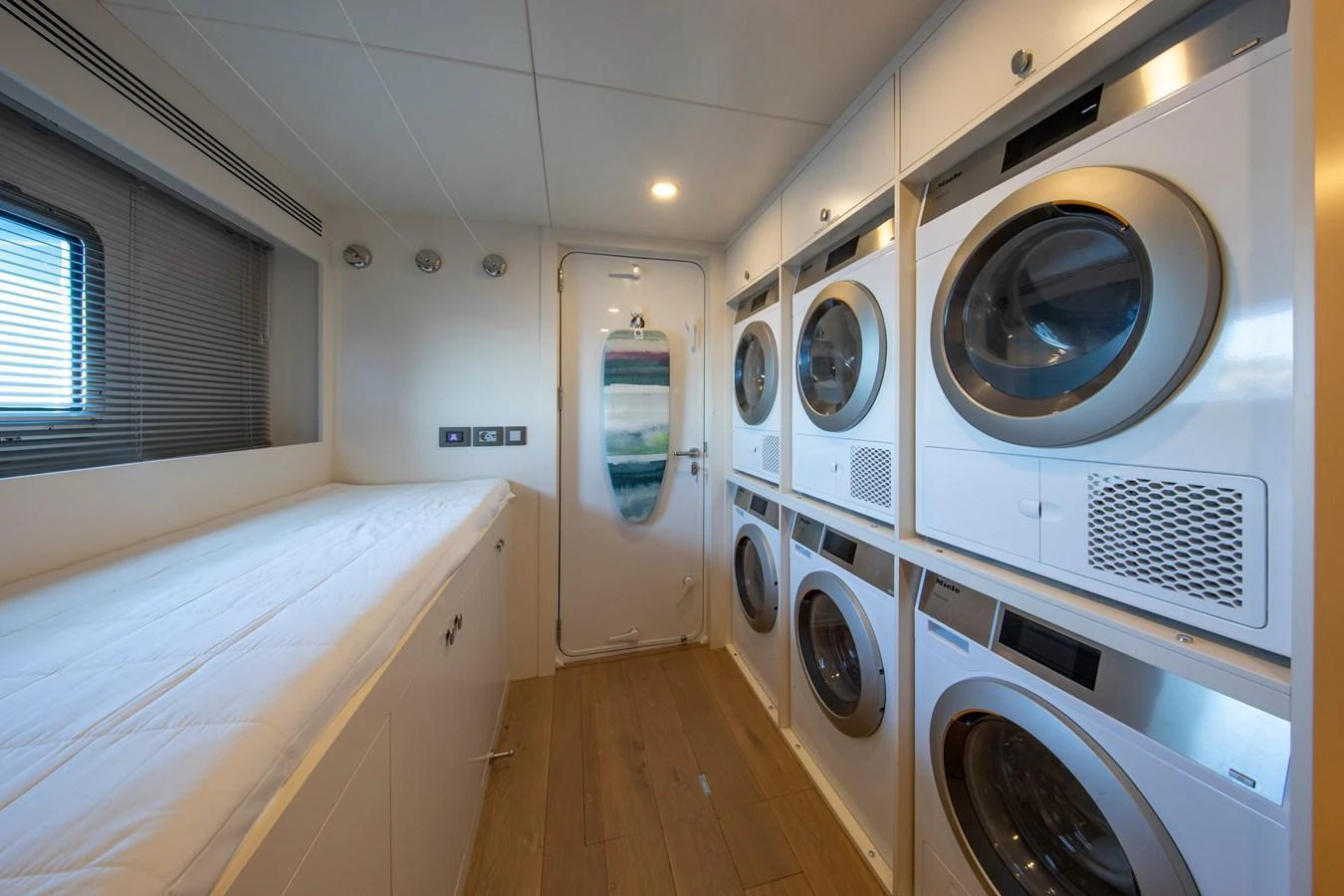 The yacht's laundry room is equipped with multiple washers and dryers for convenience. aboard OSCAR Yacht for Sale