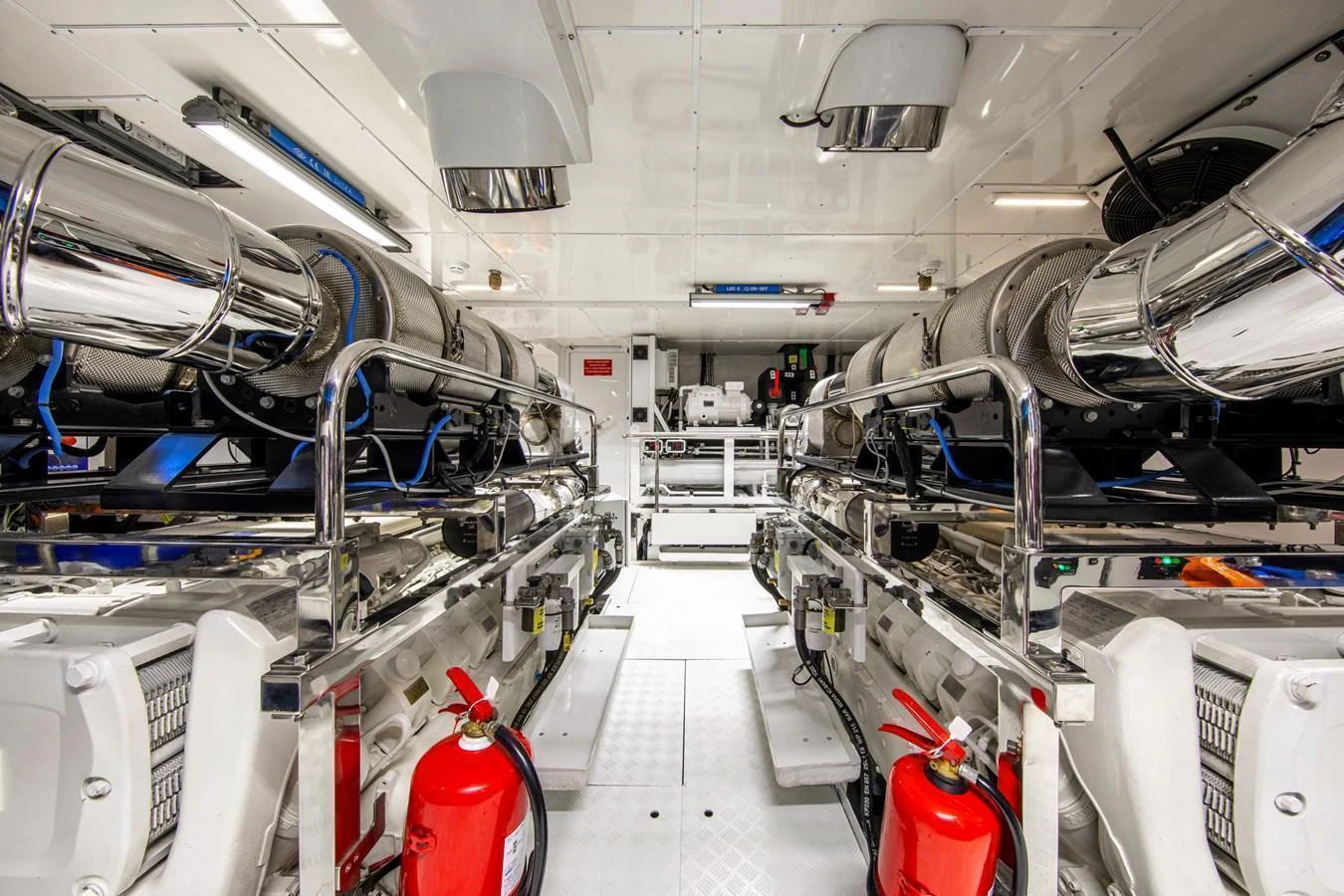 The image showcases a pristine engine room with advanced machinery and safety equipment. aboard OSCAR Yacht for Sale