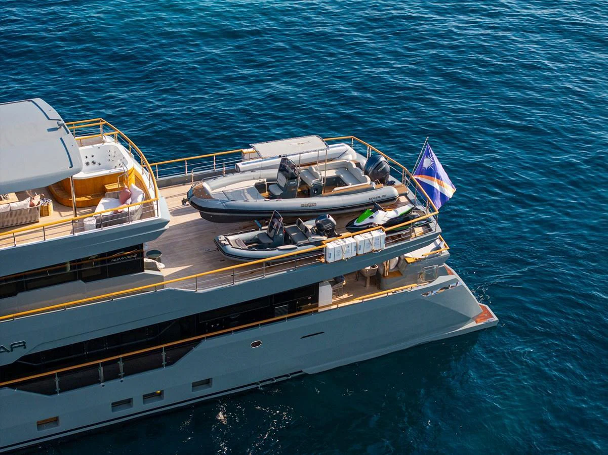 The aft deck of the yacht showcases a tender and water toys, ready for adventure on the open sea. aboard OSCAR Yacht for Sale
