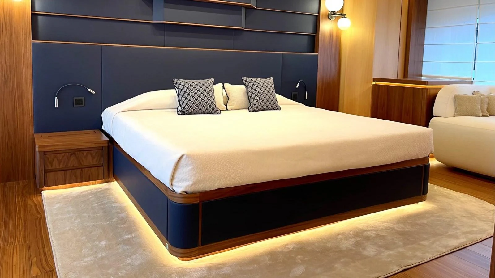 The master stateroom features a luxurious bed with elegant lighting and modern decor. aboard LADY BETTY Yacht for Sale