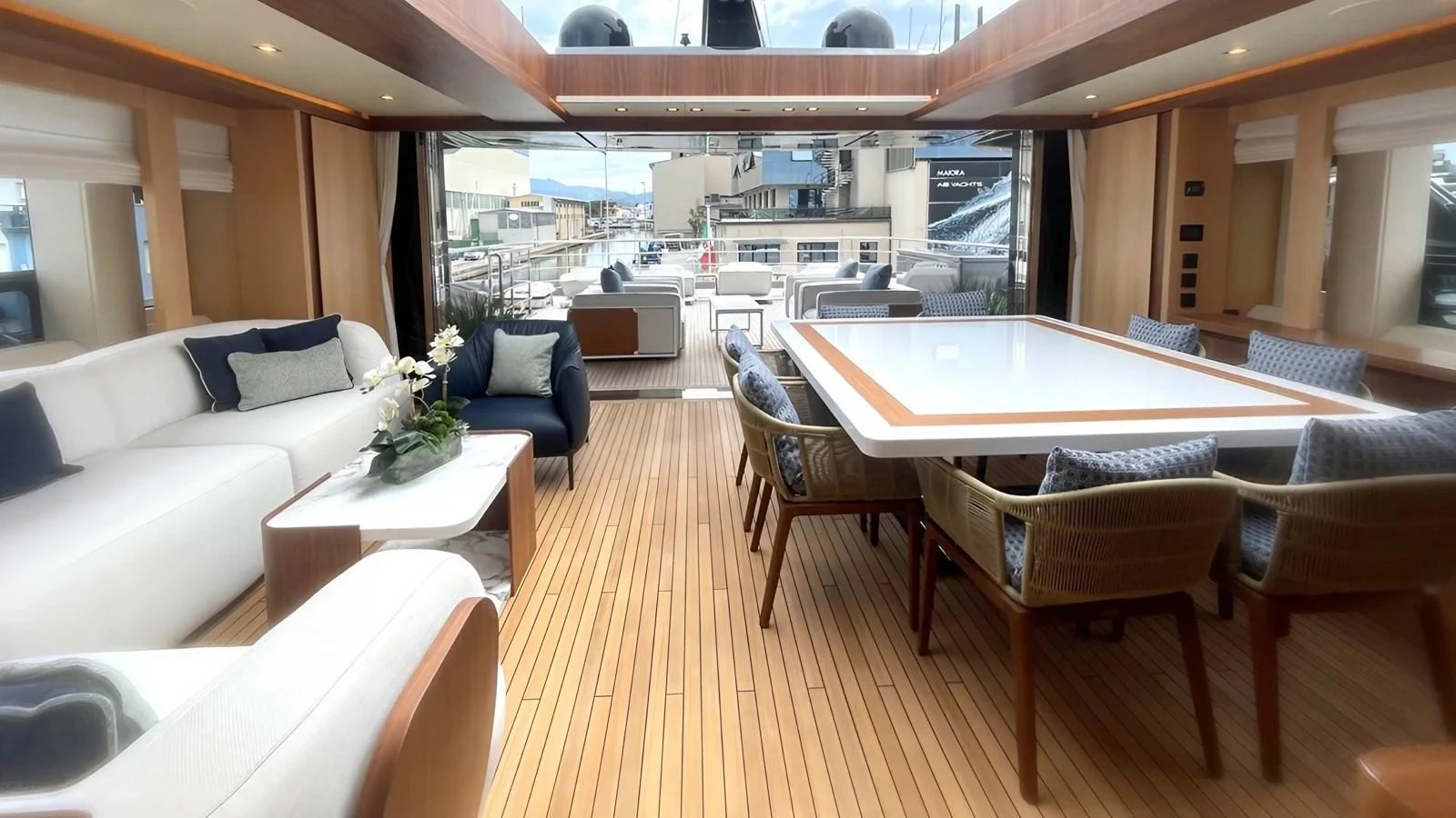 The spacious salon features elegant seating and a large dining table, perfect for entertaining guests. aboard LADY BETTY Yacht for Sale
