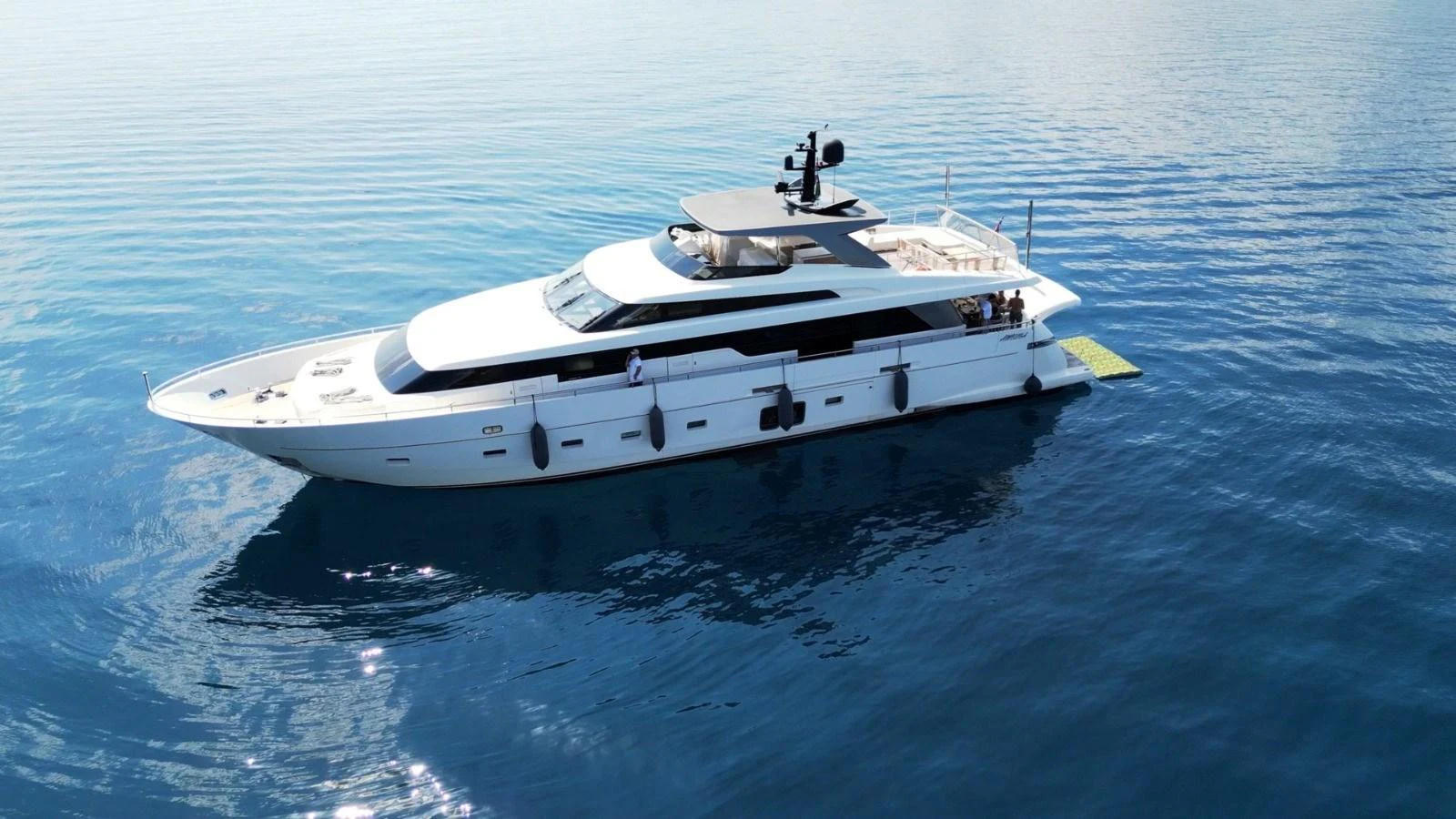 A sleek and modern yacht glides gracefully on calm blue waters. aboard SL94 Yacht for Sale