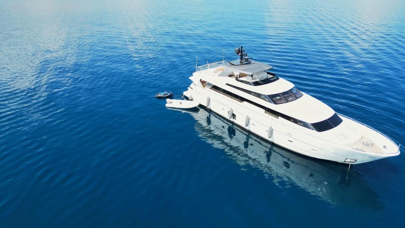 A sleek and modern yacht glides gracefully on calm, clear blue waters. aboard SL94 Yacht for Sale