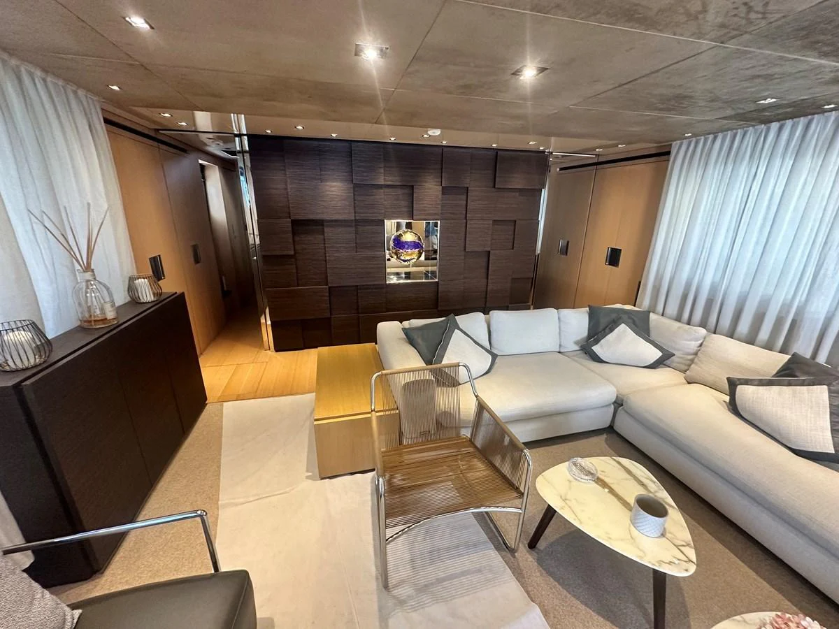 The salon features a spacious and modern seating area with elegant decor. aboard SL94 Yacht for Sale