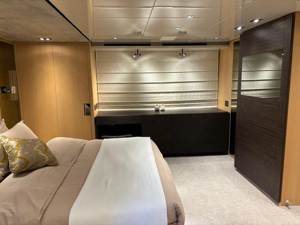 A luxurious stateroom featuring a comfortable bed and modern furnishings. aboard SL94 Yacht for Sale