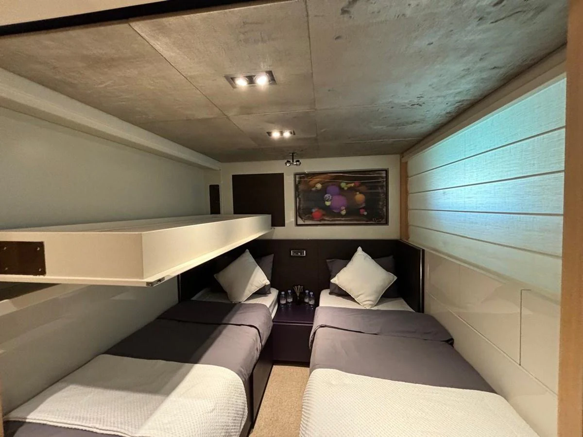 The twin stateroom offers a cozy and modern retreat with two single beds and contemporary decor. aboard SL94 Yacht for Sale