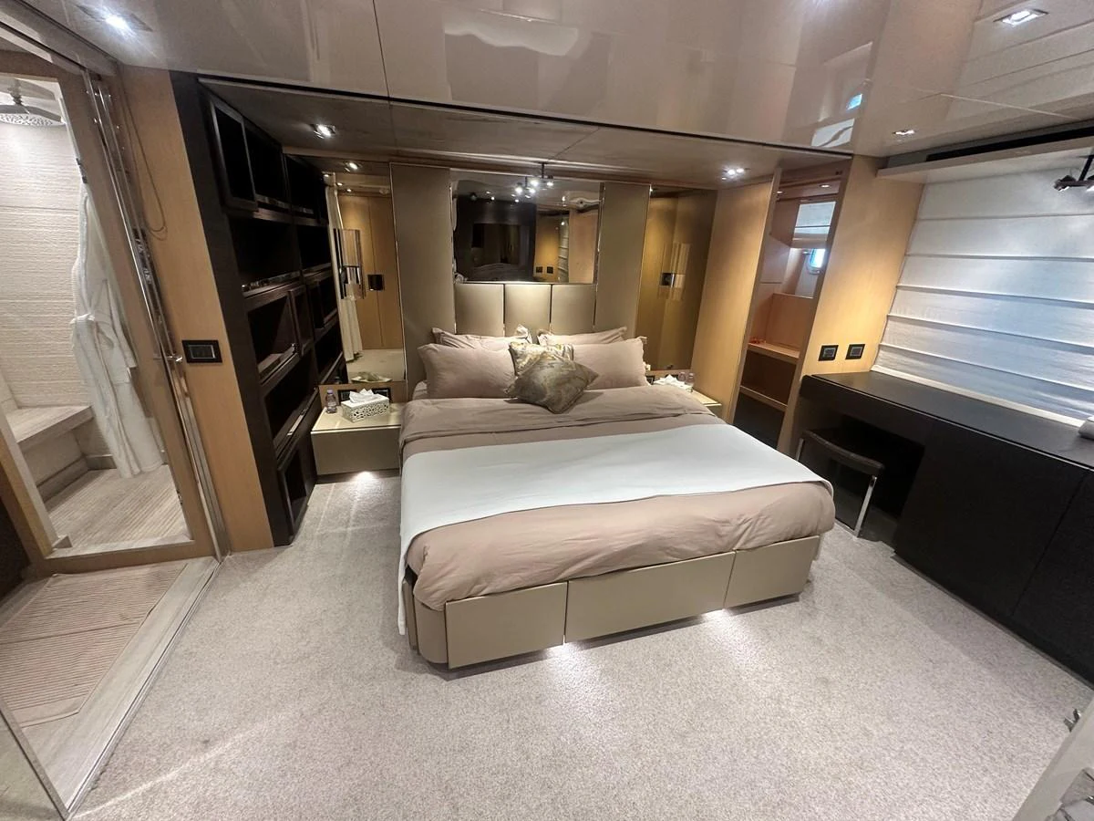 The master stateroom features a spacious bed with elegant bedding and ample storage, creating a luxurious and comfortable retreat. aboard SL94 Yacht for Sale