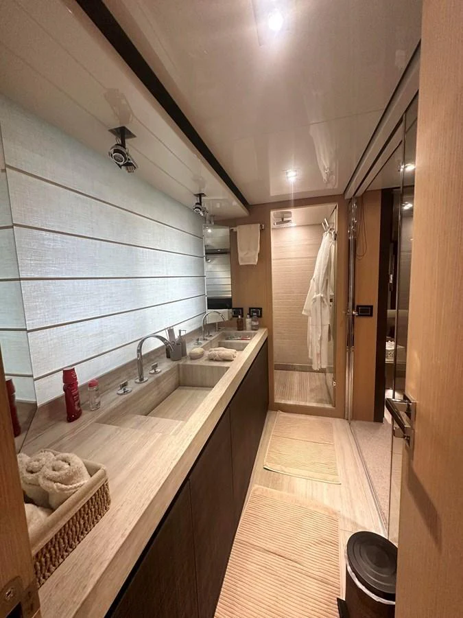The yacht's bathroom features a sleek design with modern fixtures and ample counter space. aboard SL94 Yacht for Sale