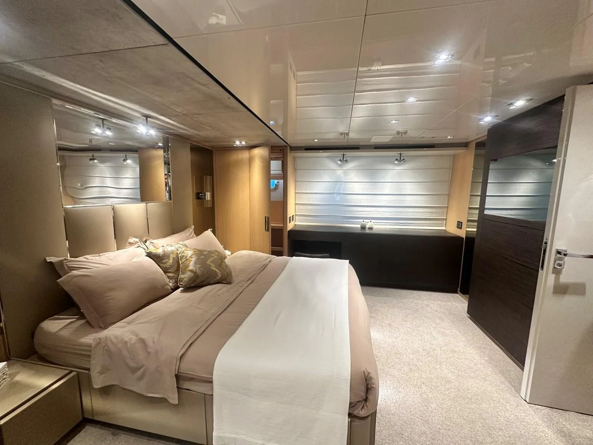 The master stateroom offers a luxurious and spacious retreat with elegant bedding and modern lighting. aboard SL94 Yacht for Sale