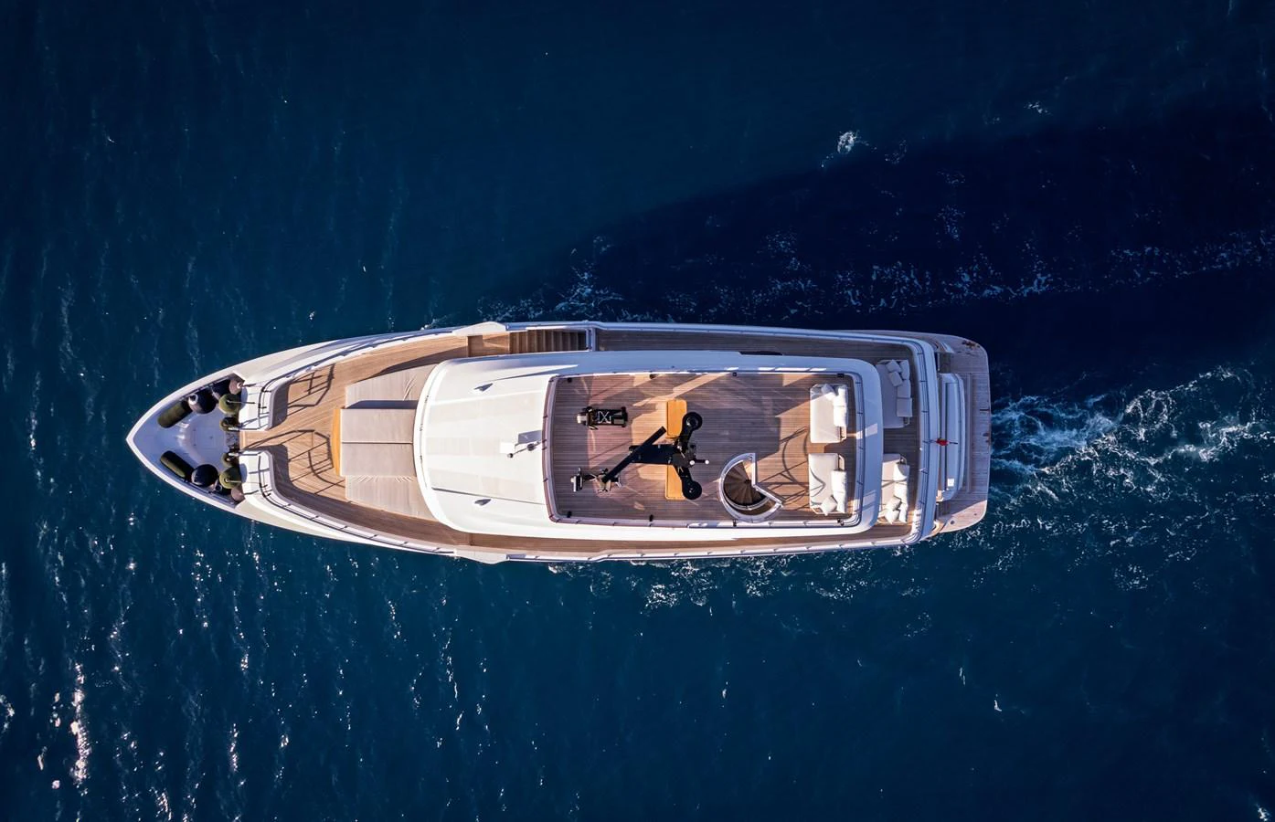 Aerial view of a luxurious yacht cruising through deep blue waters. aboard BELLE ILE Yacht for Sale