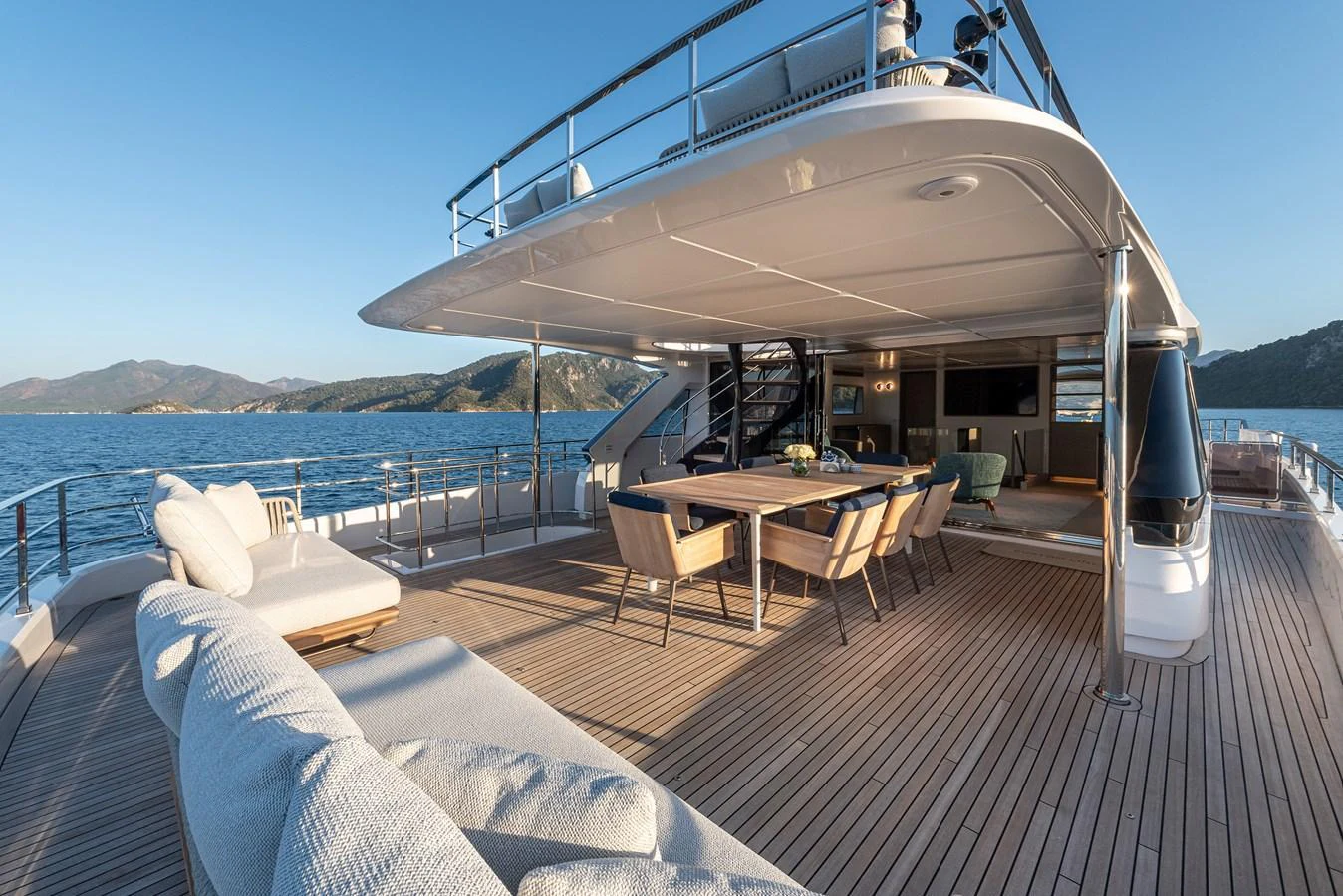 The spacious aft deck offers luxurious outdoor seating and dining with stunning sea views. aboard BELLE ILE Yacht for Sale