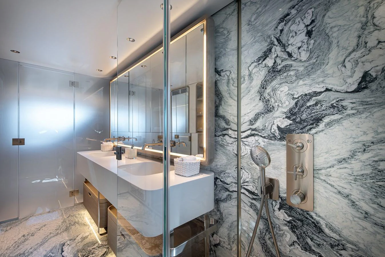 The yacht's bathroom features a luxurious design with marble walls and modern fixtures. aboard BELLE ILE Yacht for Sale