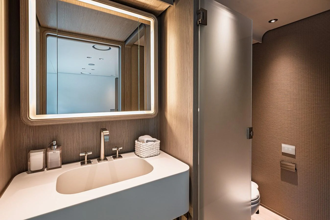 A modern and elegant yacht bathroom with sleek fixtures and ambient lighting. aboard BELLE ILE Yacht for Sale