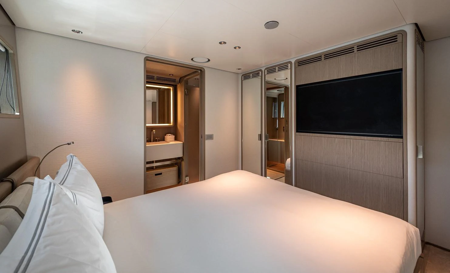 The stateroom features a spacious bed, modern decor, and an ensuite bathroom. aboard BELLE ILE Yacht for Sale