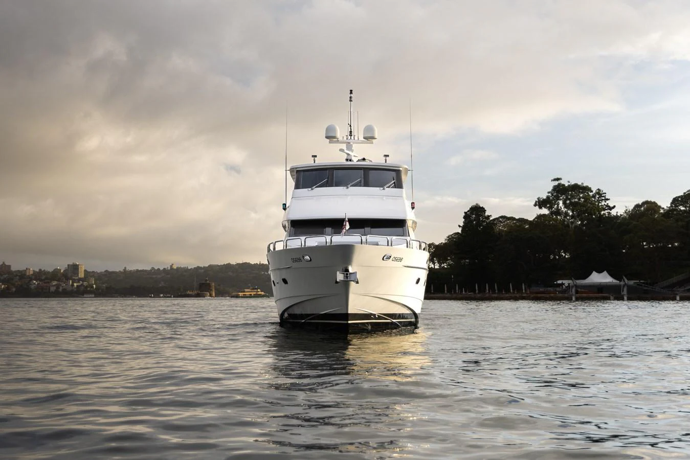 A luxurious yacht is anchored on calm waters with a scenic backdrop. aboard SASSY Yacht for Sale