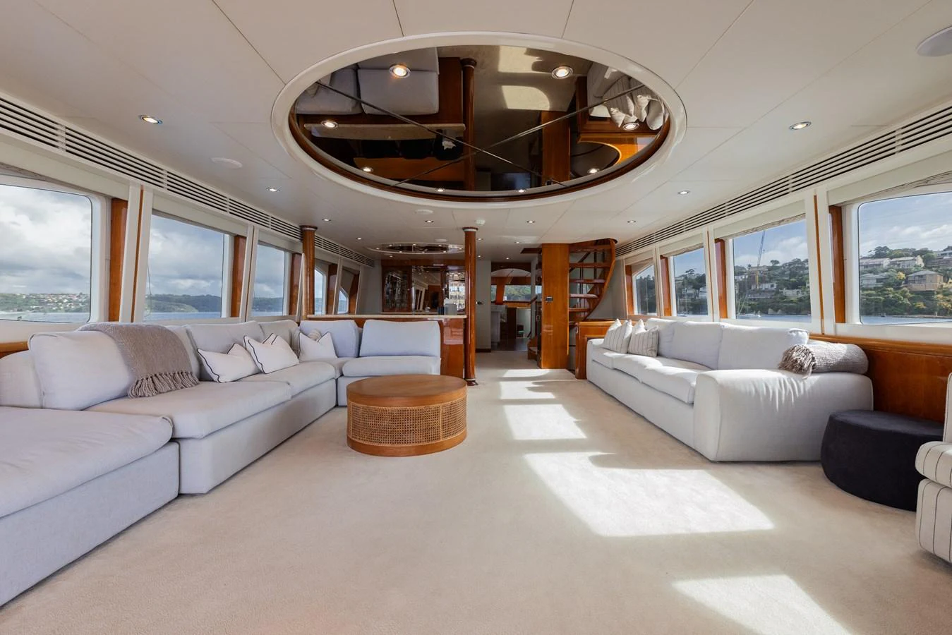 The spacious salon features plush seating and large windows for panoramic views. aboard SASSY Yacht for Sale