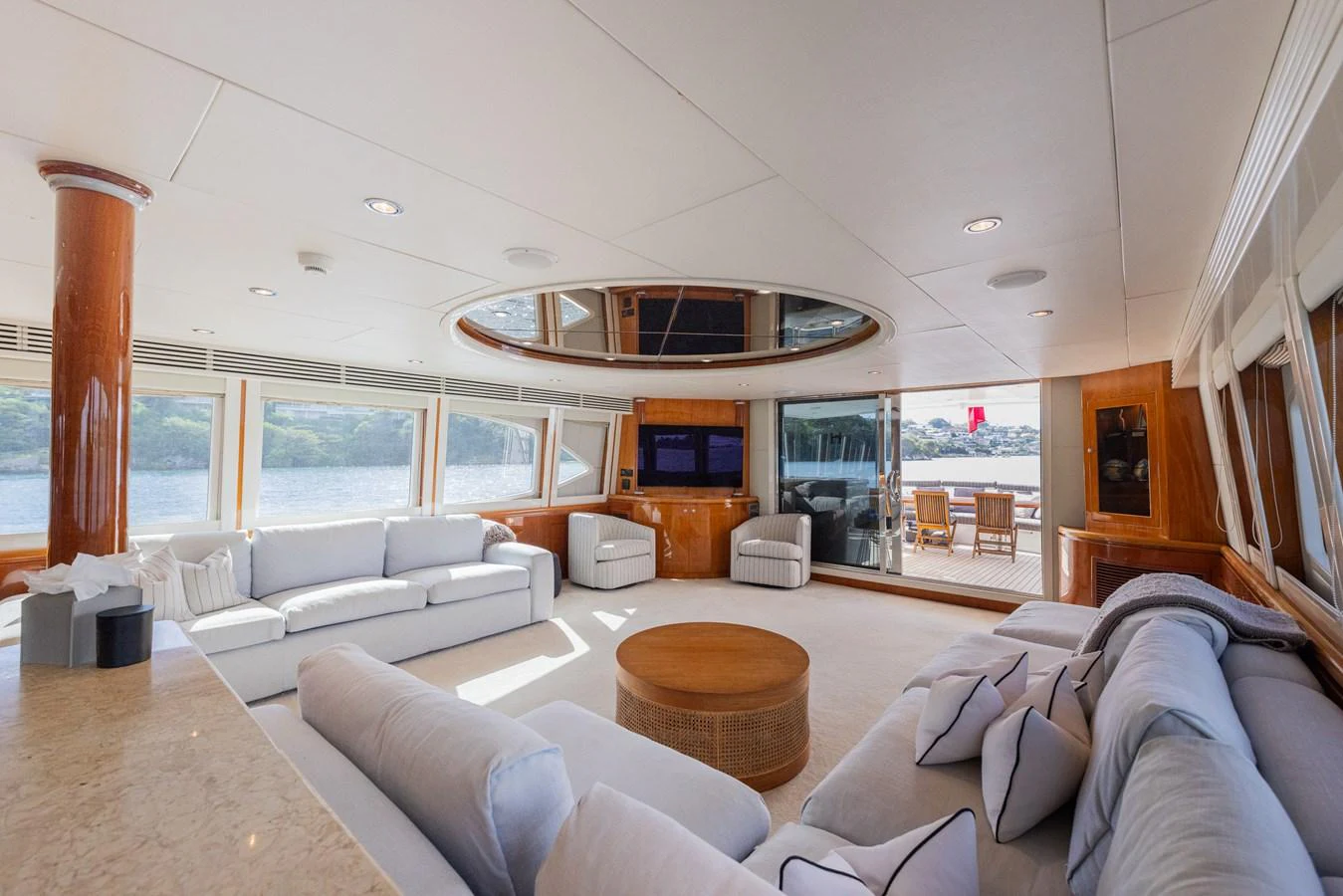 The spacious salon features plush seating and large windows offering panoramic views. aboard SASSY Yacht for Sale