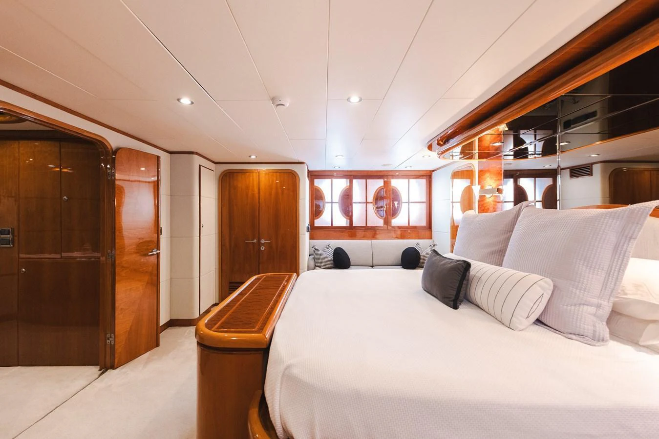 The master stateroom features luxurious bedding and elegant wood finishes, creating a serene and comfortable retreat. aboard SASSY Yacht for Sale
