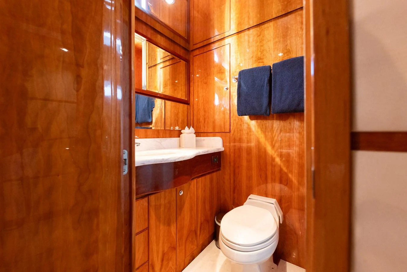 The yacht's bathroom features elegant wooden paneling and modern fixtures. aboard SASSY Yacht for Sale