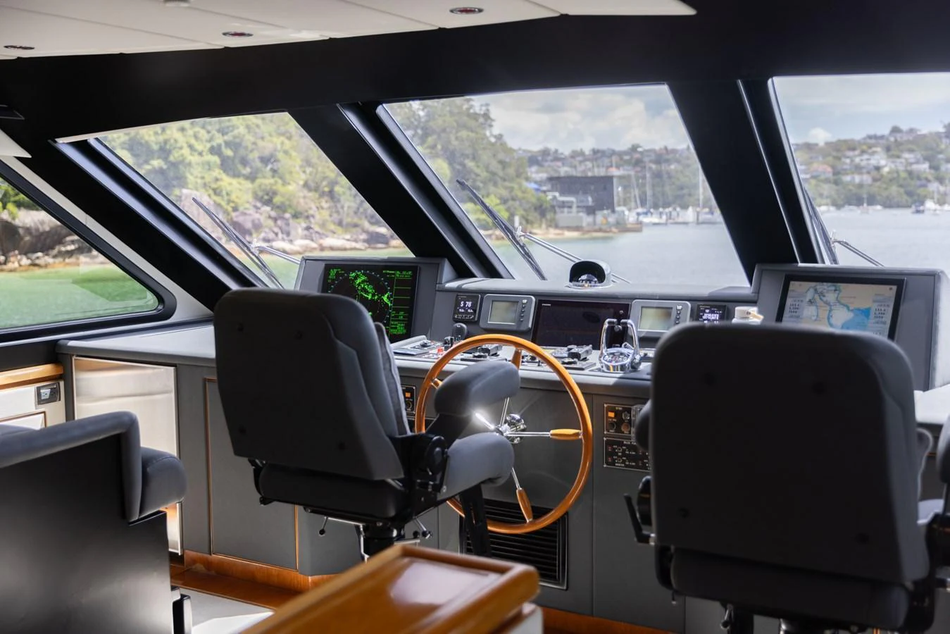 The helm station offers a commanding view with state-of-the-art navigation equipment and comfortable seating. aboard SASSY Yacht for Sale
