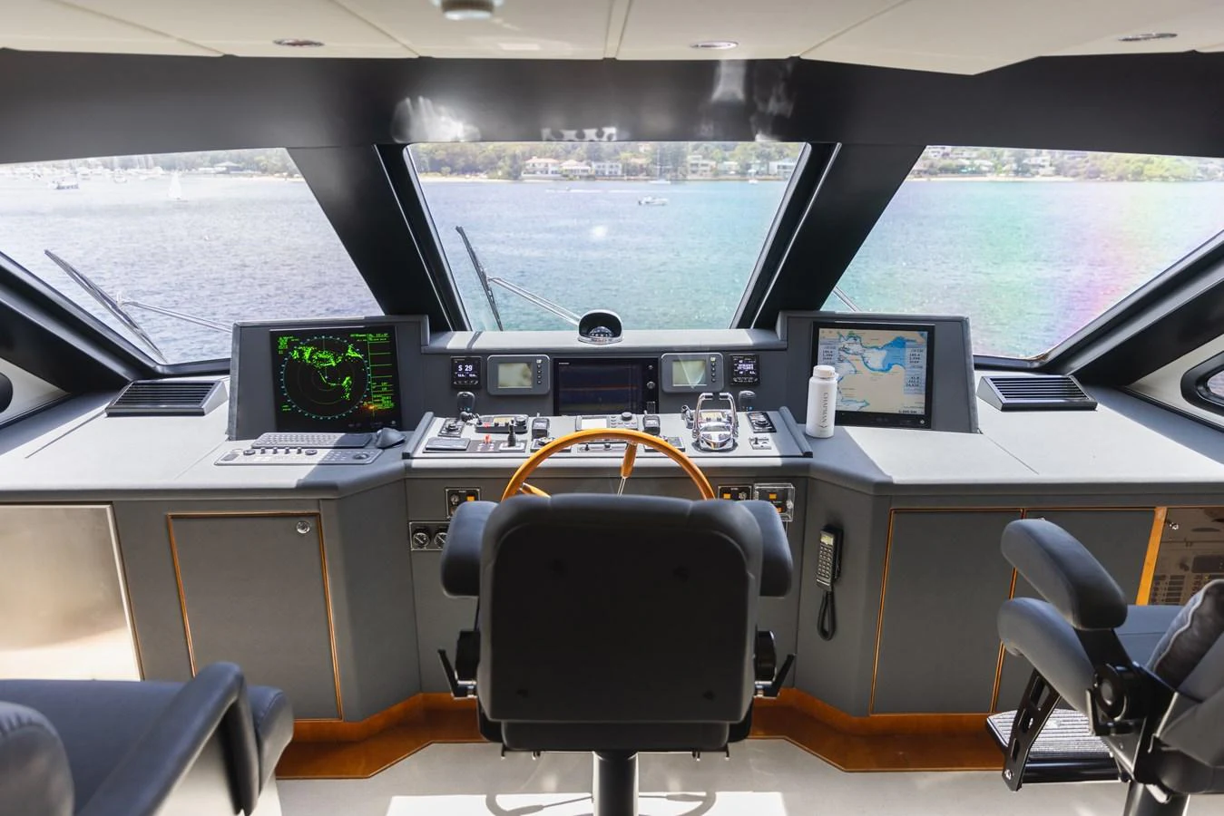 The helm station offers a commanding view with advanced navigation equipment and a sleek design. aboard SASSY Yacht for Sale