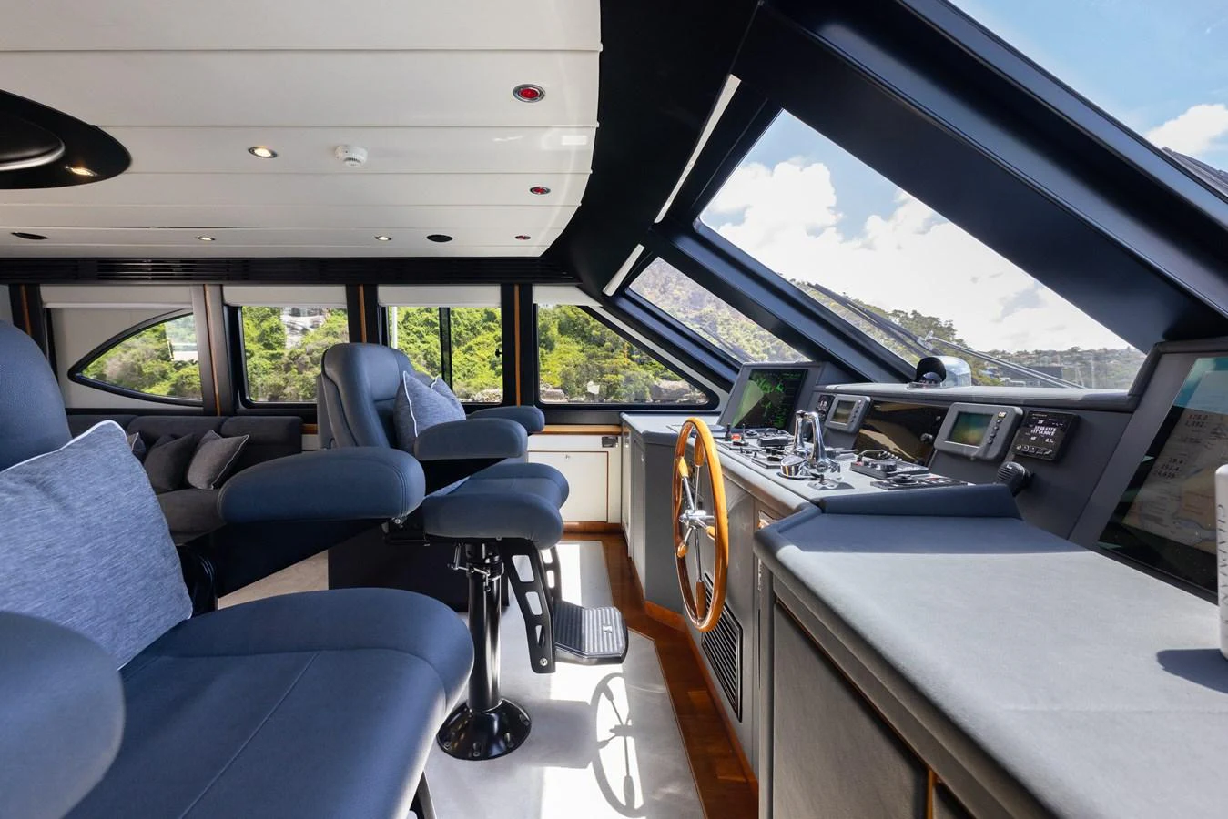 The helm station features modern navigation equipment and comfortable seating with panoramic views. aboard SASSY Yacht for Sale