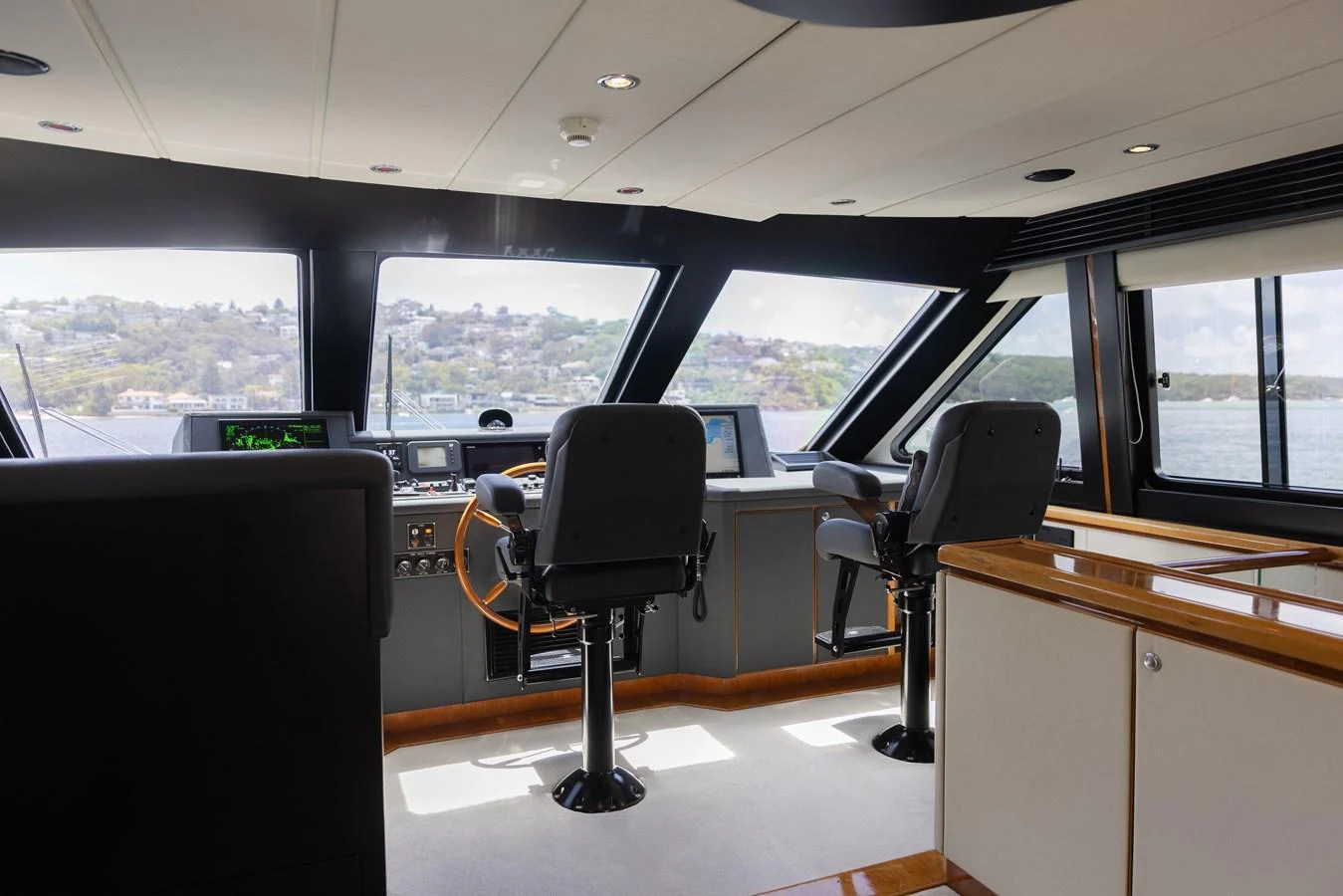 The helm station offers a commanding view with modern navigation equipment and comfortable seating. aboard SASSY Yacht for Sale