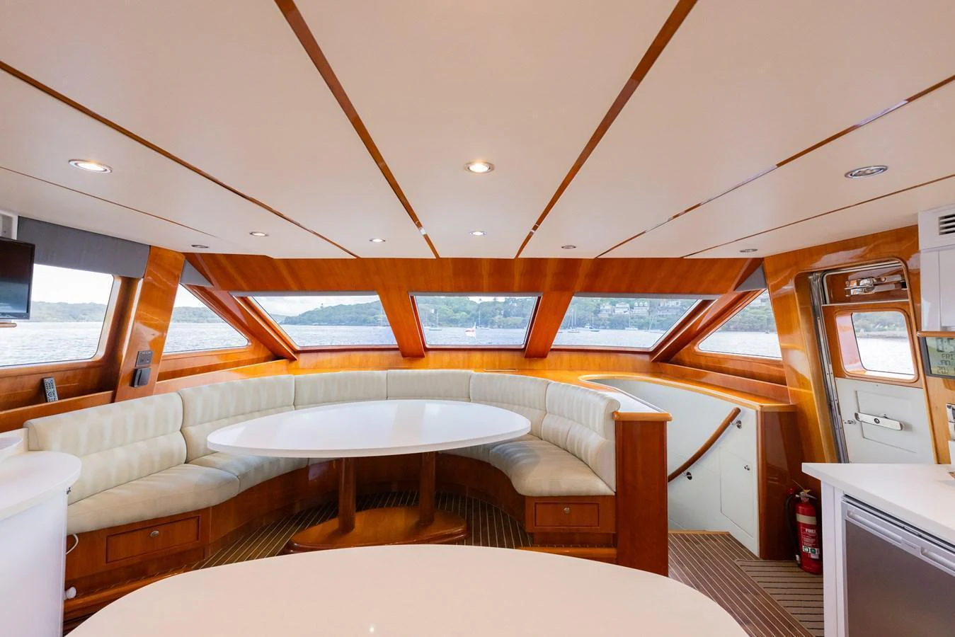 The yacht's saloon features a spacious seating area with panoramic windows offering stunning views. aboard SASSY Yacht for Sale
