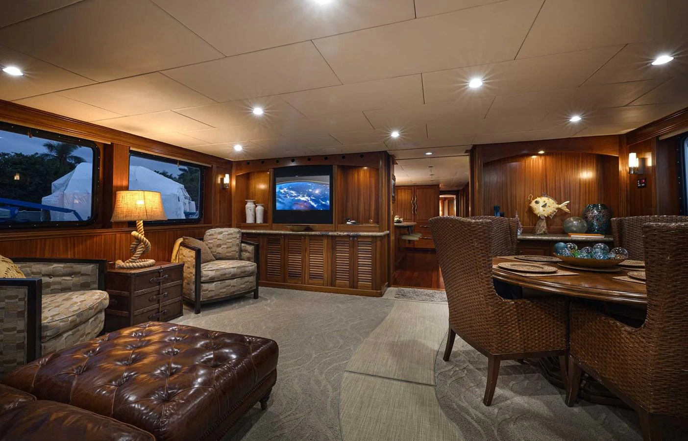 The salon features luxurious seating, warm lighting, and elegant decor, creating a cozy and inviting atmosphere. aboard HEAVEN'S GATE Yacht for Sale
