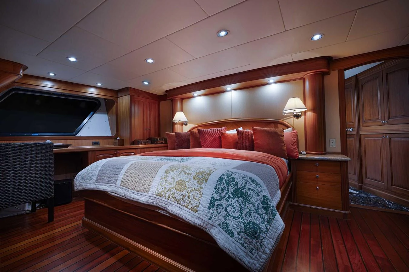 The master stateroom features a luxurious bed with elegant bedding and warm wooden accents. aboard HEAVEN'S GATE Yacht for Sale