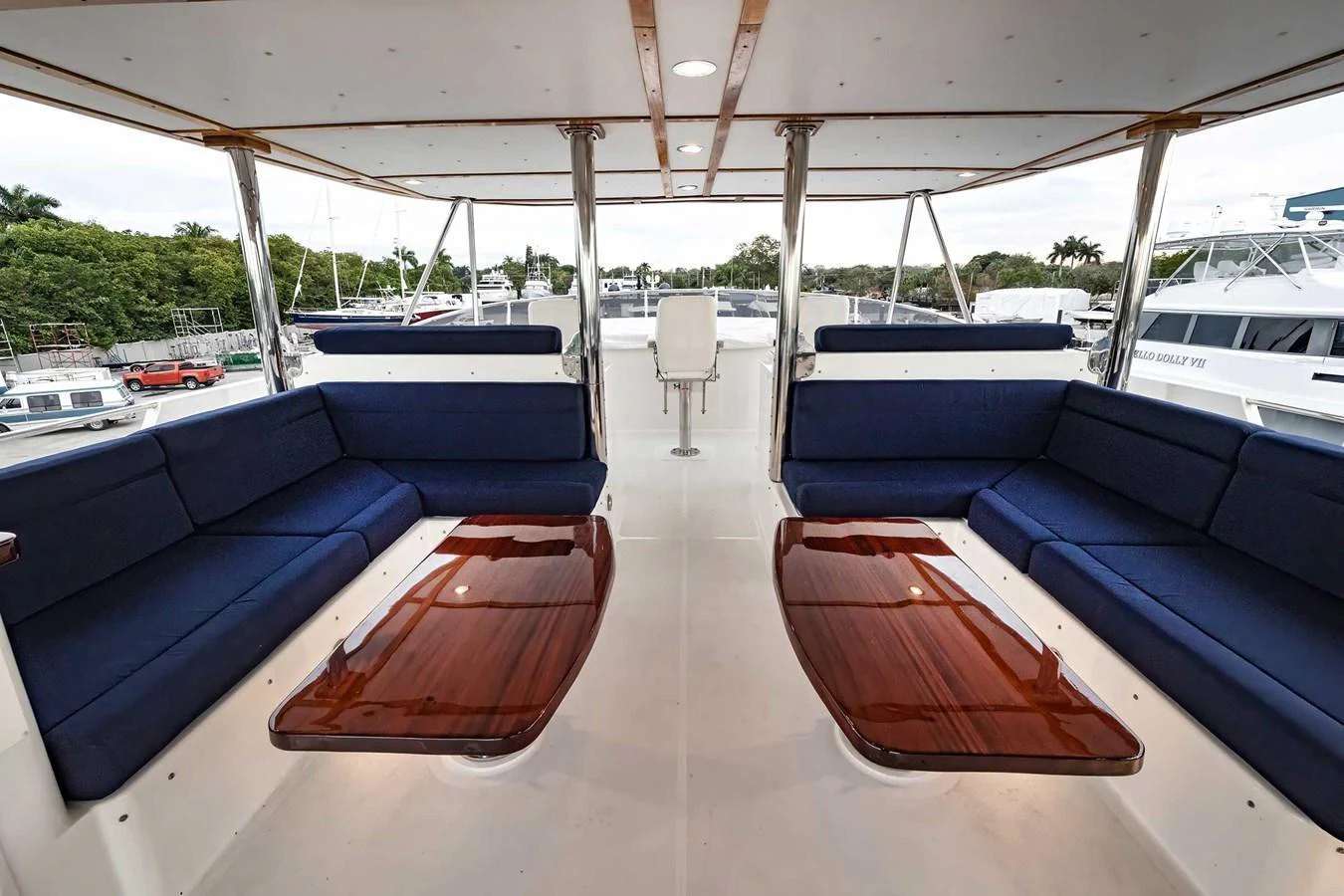 The flybridge features comfortable seating areas with elegant wooden tables. aboard HEAVEN'S GATE Yacht for Sale