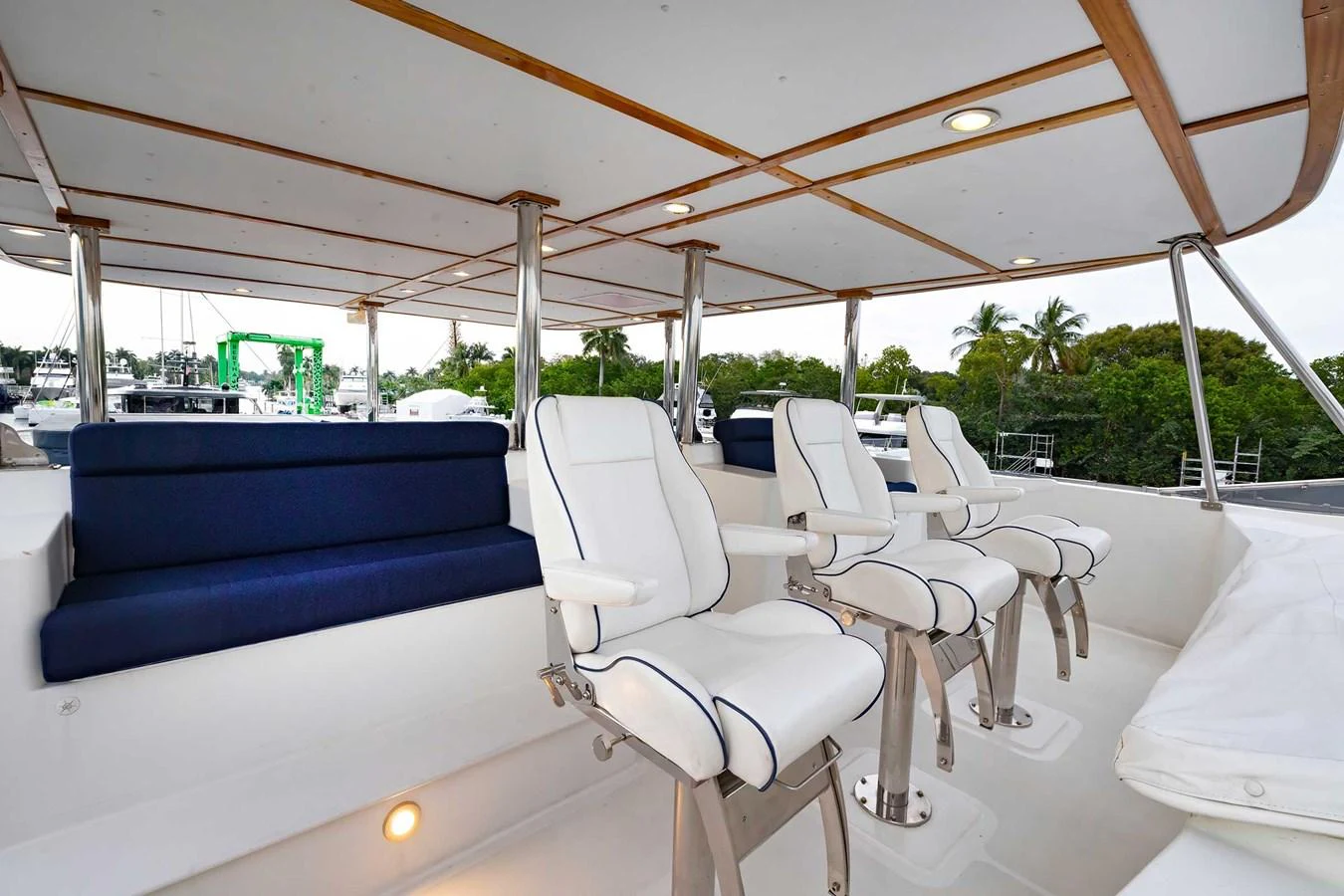 The flybridge features comfortable white seating with a sleek design and a spacious layout. aboard HEAVEN'S GATE Yacht for Sale