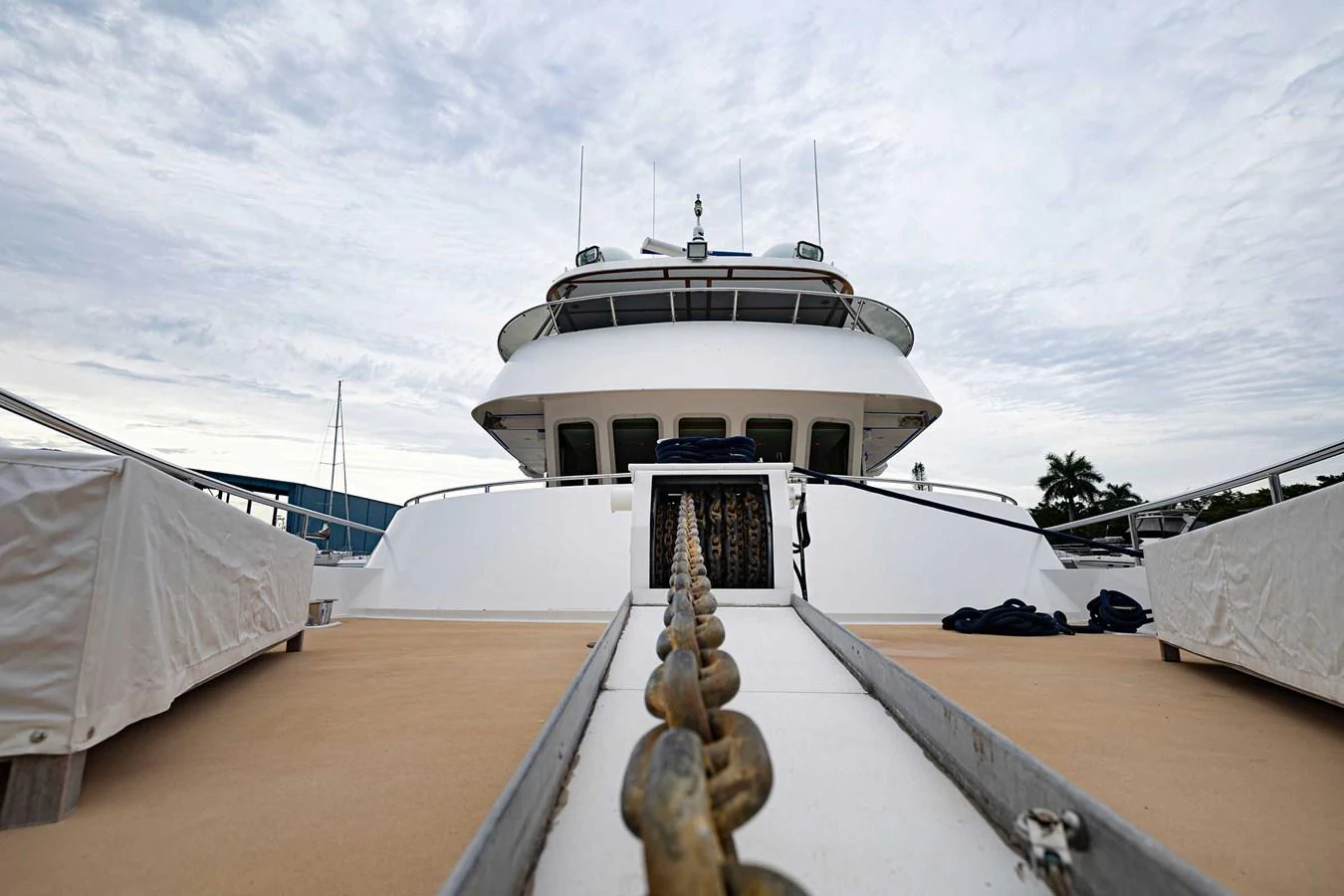 The yacht's bow is showcased with a focus on the anchor chain leading up to the deck. aboard HEAVEN'S GATE Yacht for Sale