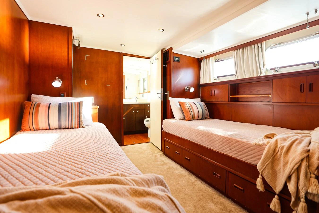 A cozy guest stateroom featuring twin beds and warm wood finishes. aboard VICTORIA Yacht for Sale