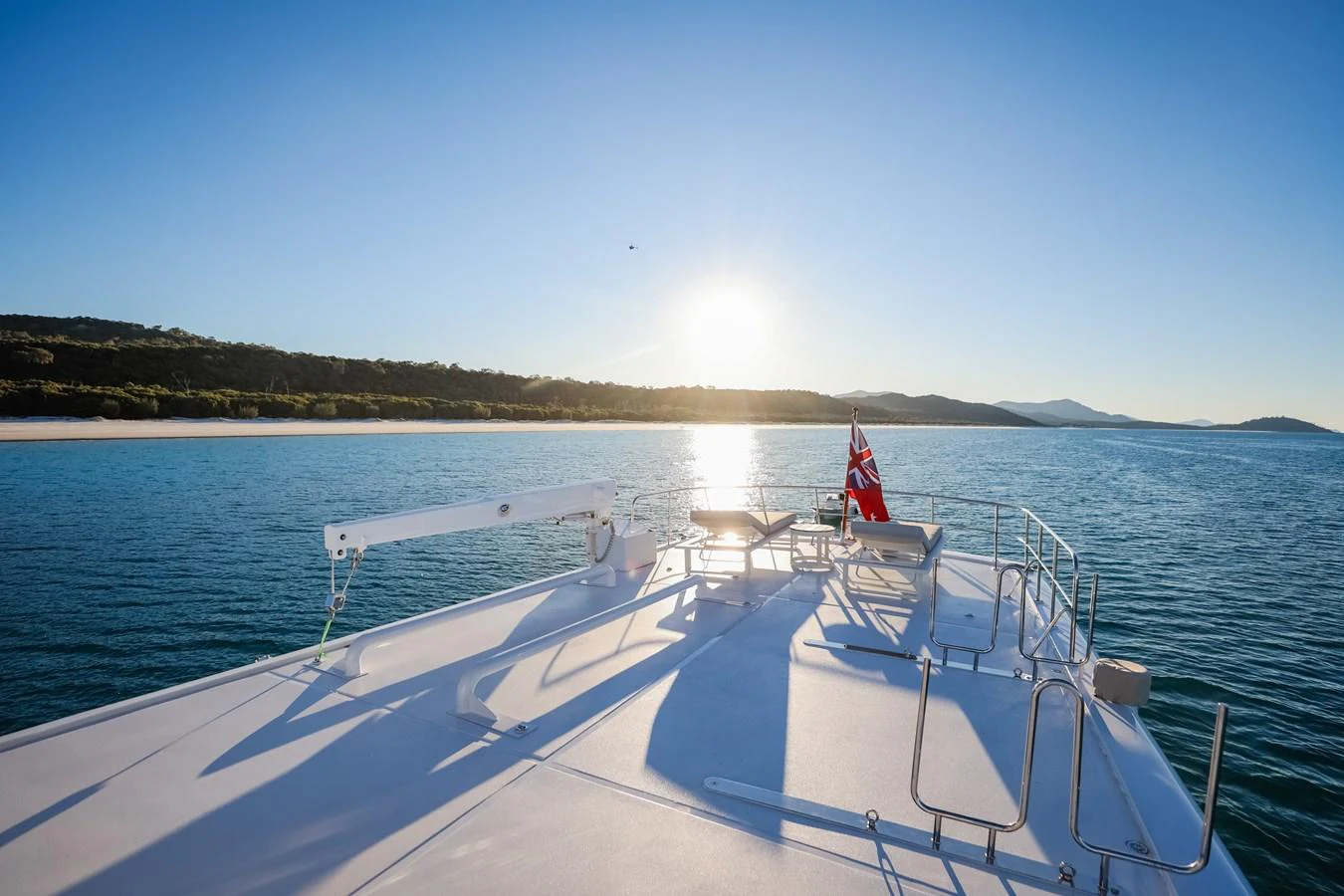 The sundeck offers a serene view of the coastline under a clear sky. aboard VICTORIA Yacht for Sale