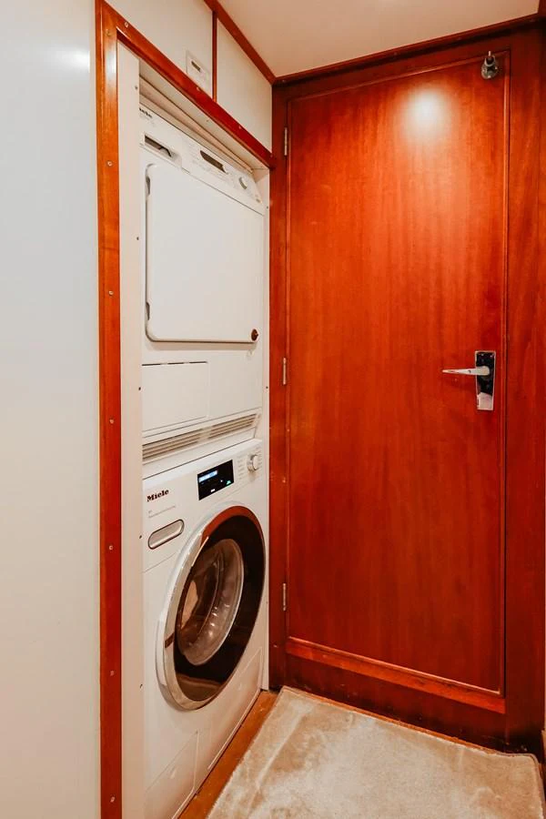 The yacht features a compact and efficient laundry area with modern appliances. aboard VICTORIA Yacht for Sale