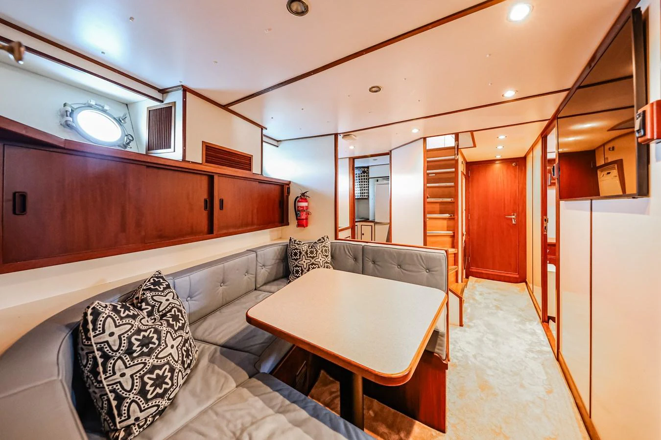 The yacht's interior dining area features a cozy seating arrangement with a table and stylish decor. aboard VICTORIA Yacht for Sale