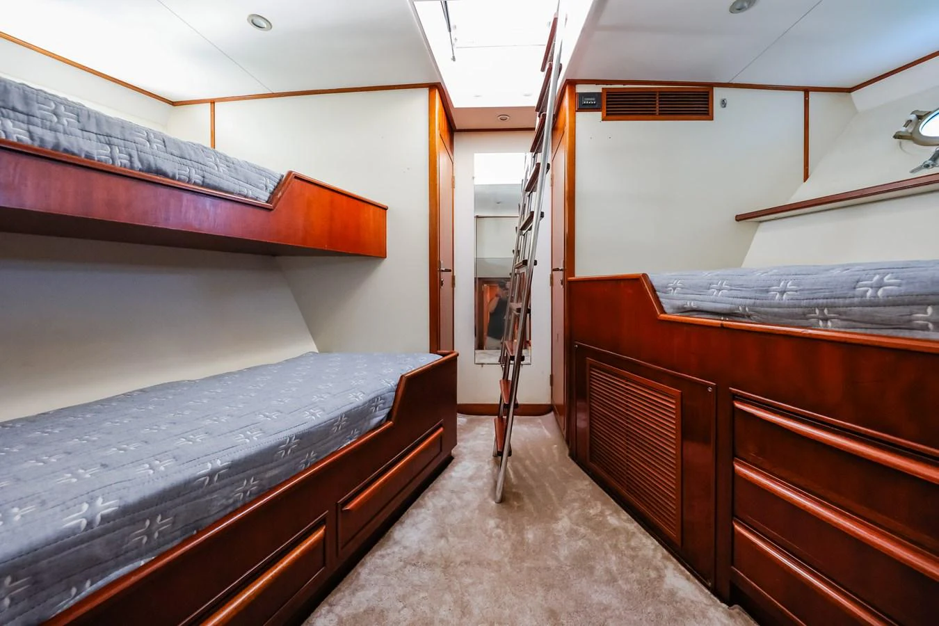 This cozy cabin features multiple bunk beds and a ladder leading to an upper area, perfect for accommodating guests. aboard VICTORIA Yacht for Sale