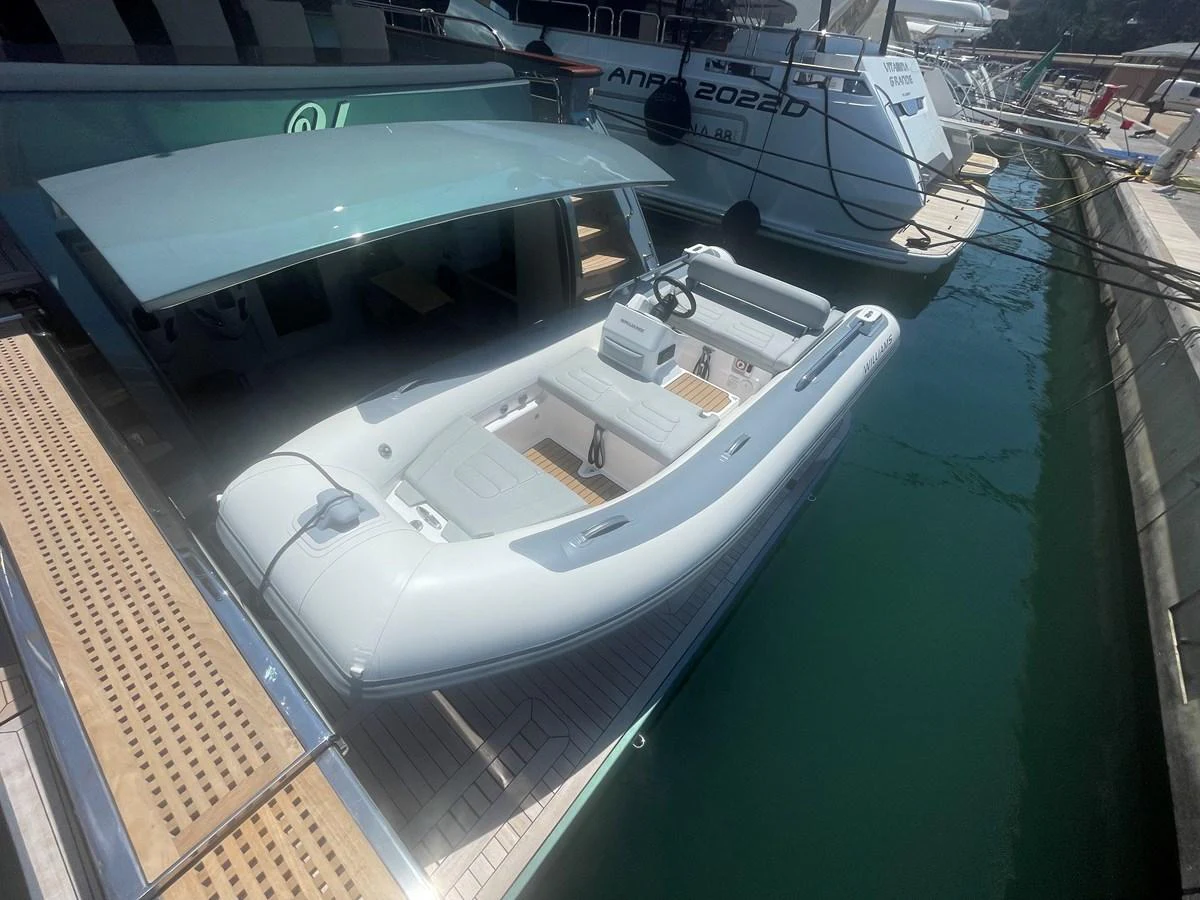 A sleek tender is docked beside a yacht, ready for excursions. aboard UNICA Yacht for Sale