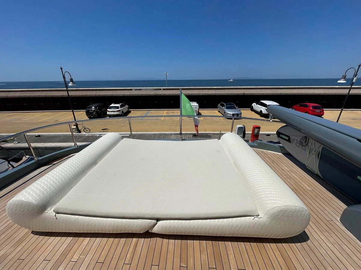 The sundeck features a luxurious sunbed with a stunning view of the waterfront. aboard UNICA Yacht for Sale