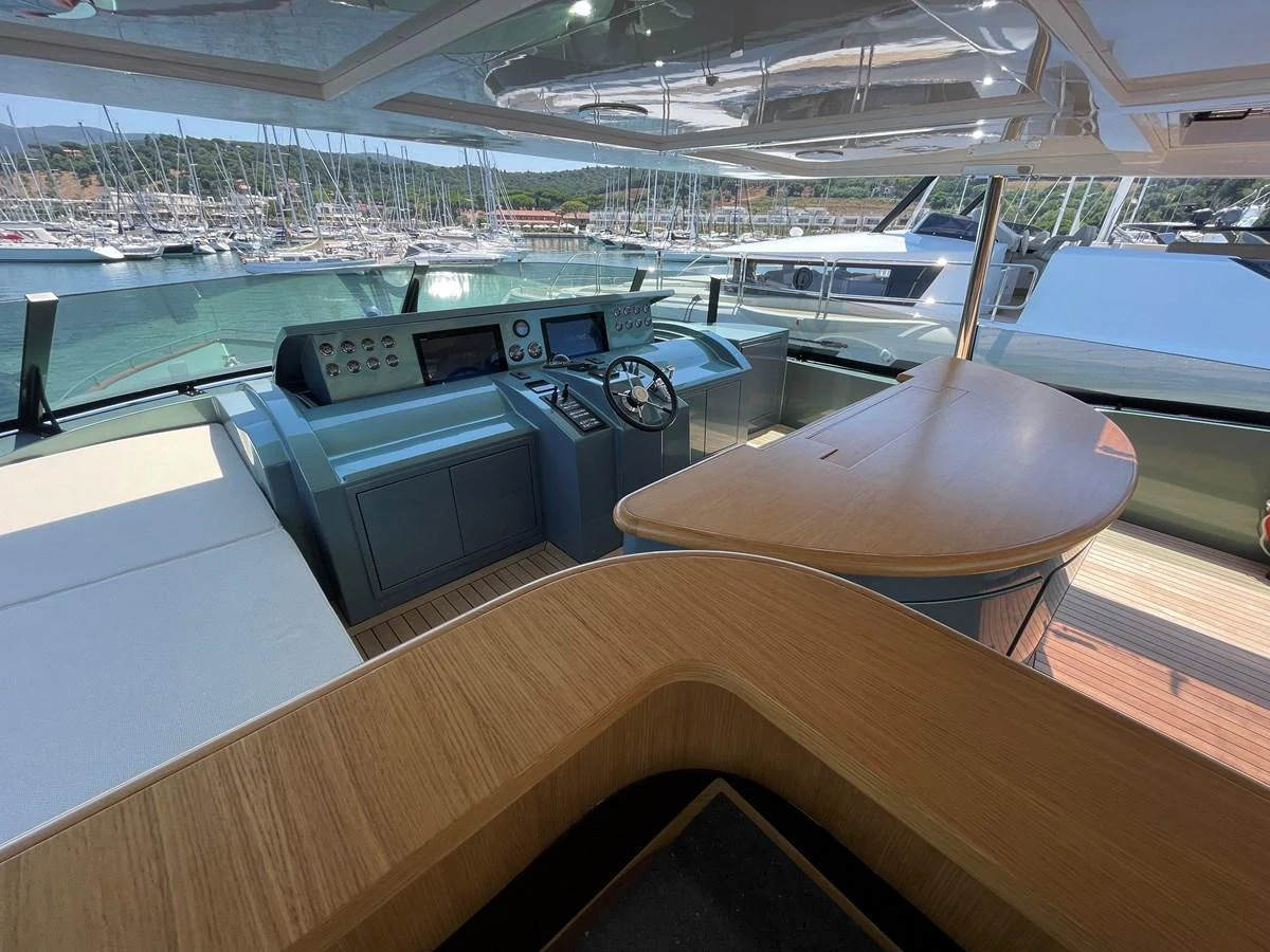 The helm station offers a commanding view with modern navigation equipment and a sleek design. aboard UNICA Yacht for Sale