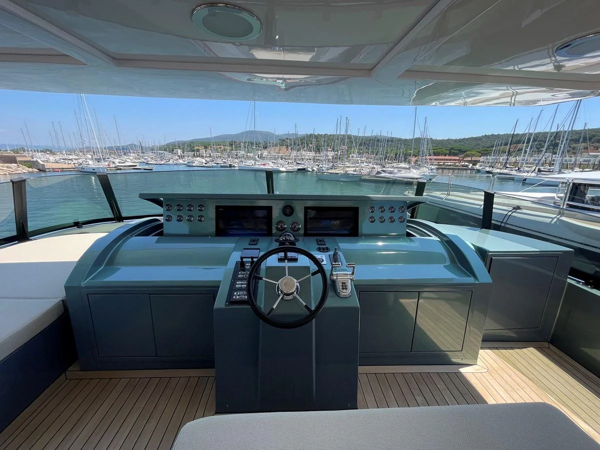 The yacht's helm offers a sophisticated control center with a panoramic view of the marina. aboard UNICA Yacht for Sale