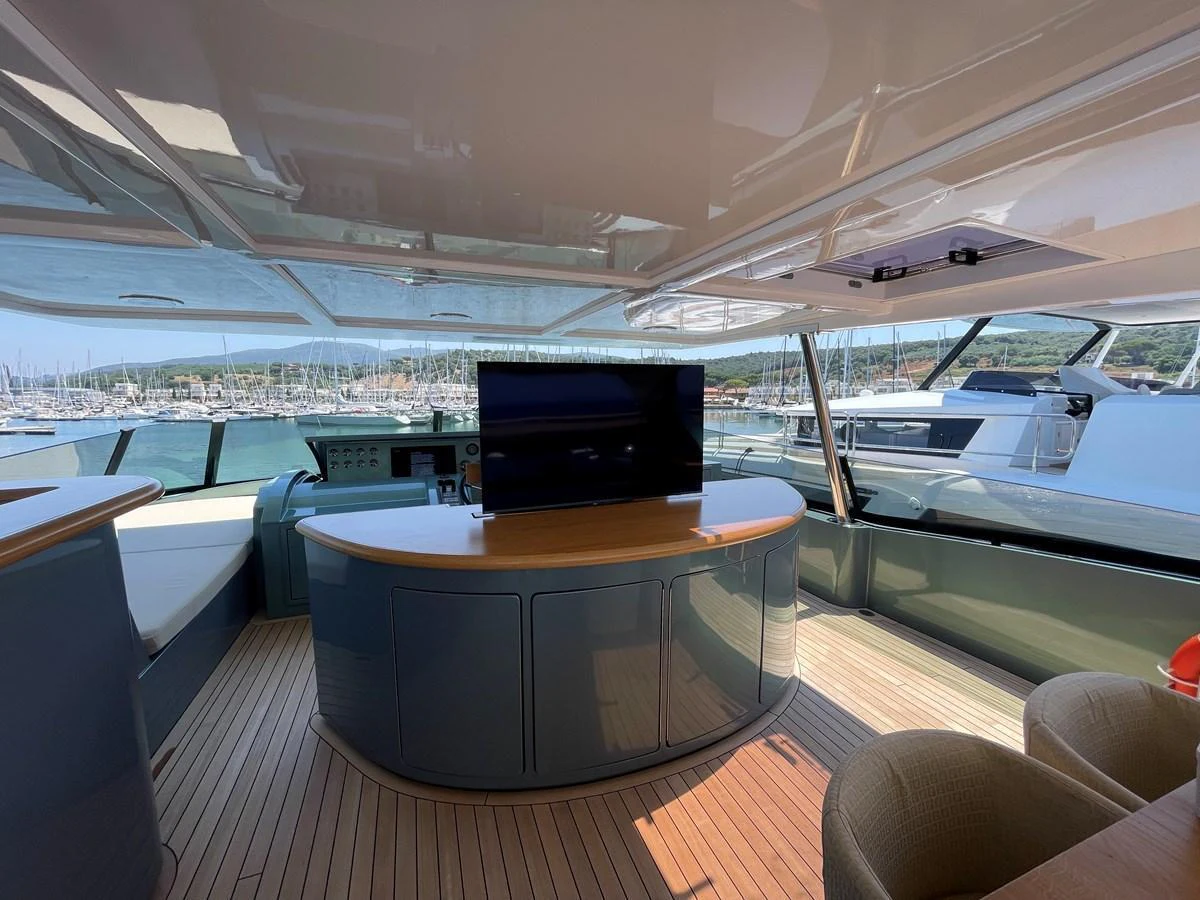 The salon offers a spacious and modern area with a large TV and ample seating, perfect for relaxation and entertainment. aboard UNICA Yacht for Sale