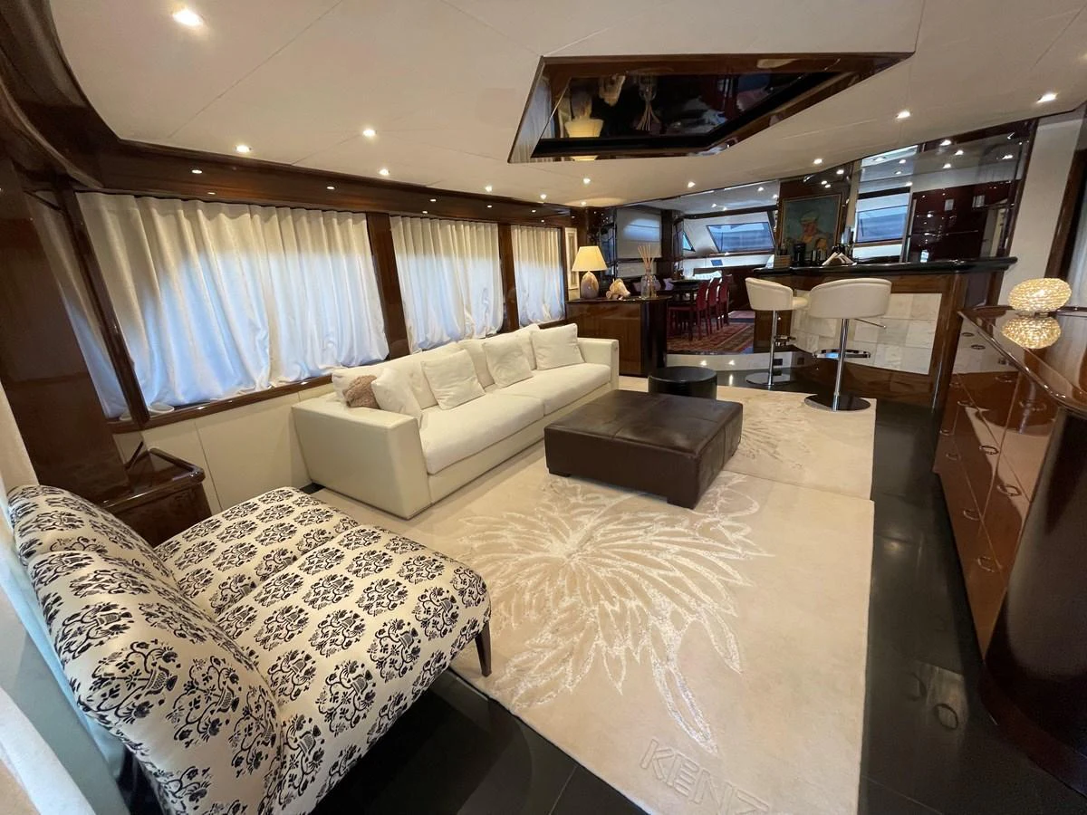 The yacht's salon features a luxurious seating area with elegant furnishings and ample natural light. aboard UNICA Yacht for Sale