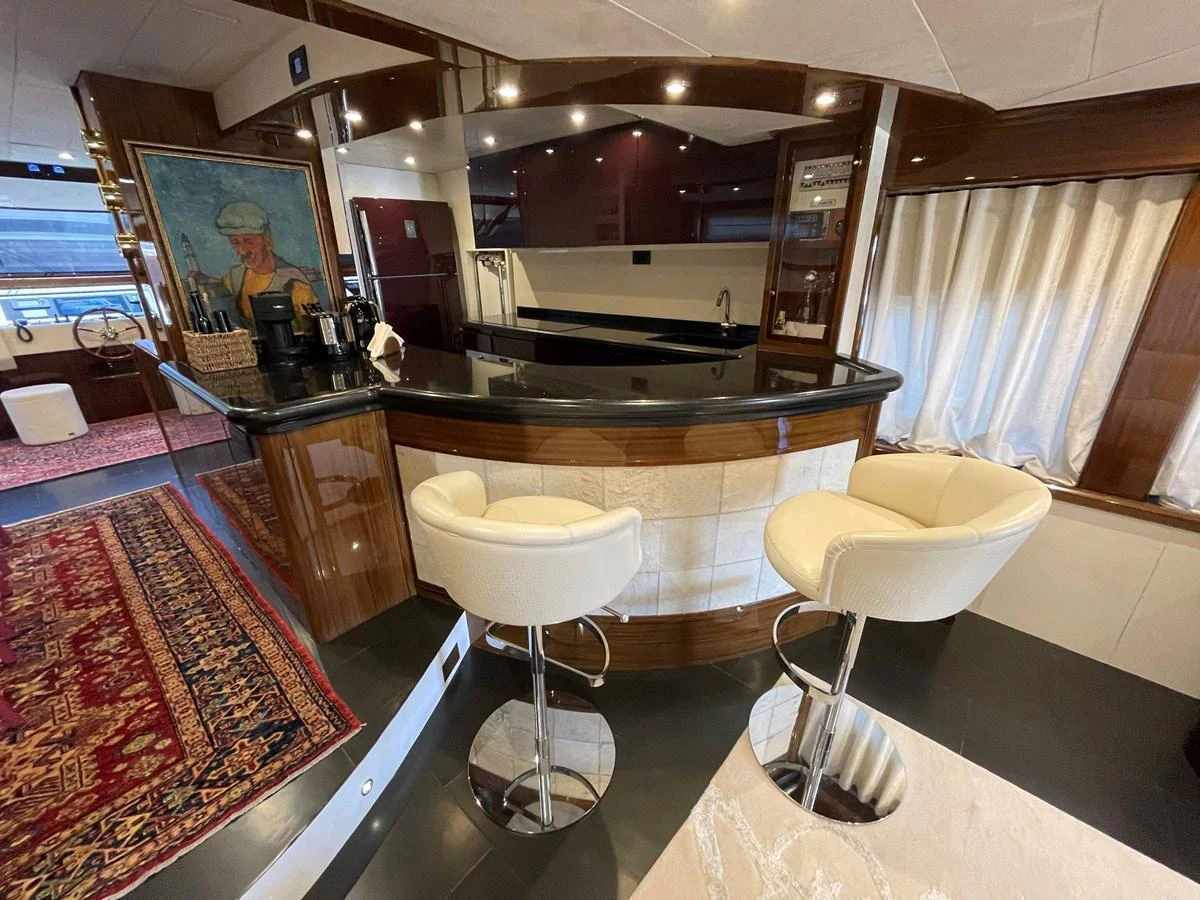 The yacht's interior features a stylish bar area with modern seating and elegant decor. aboard UNICA Yacht for Sale