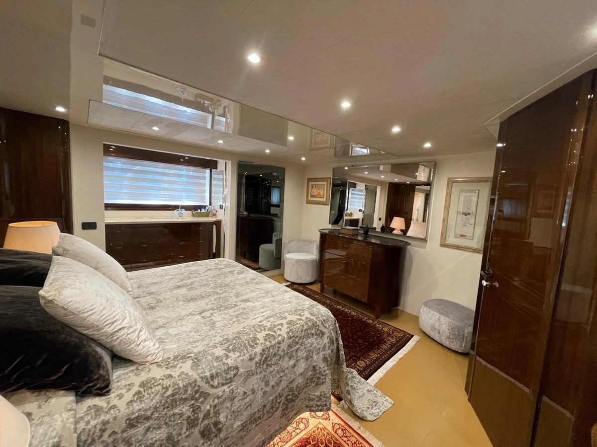 The master stateroom features elegant decor with luxurious bedding and ample storage. aboard UNICA Yacht for Sale